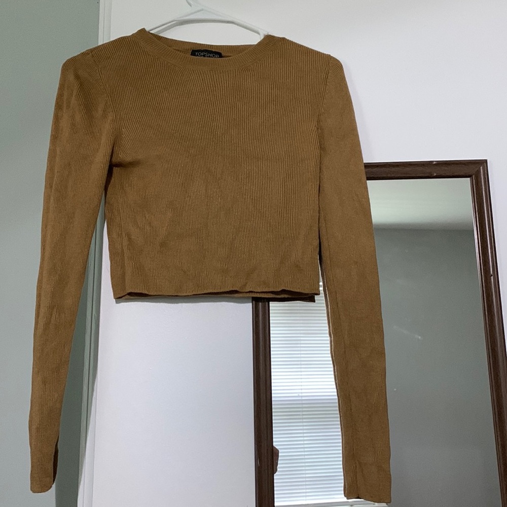 Tan long-sleeved top.